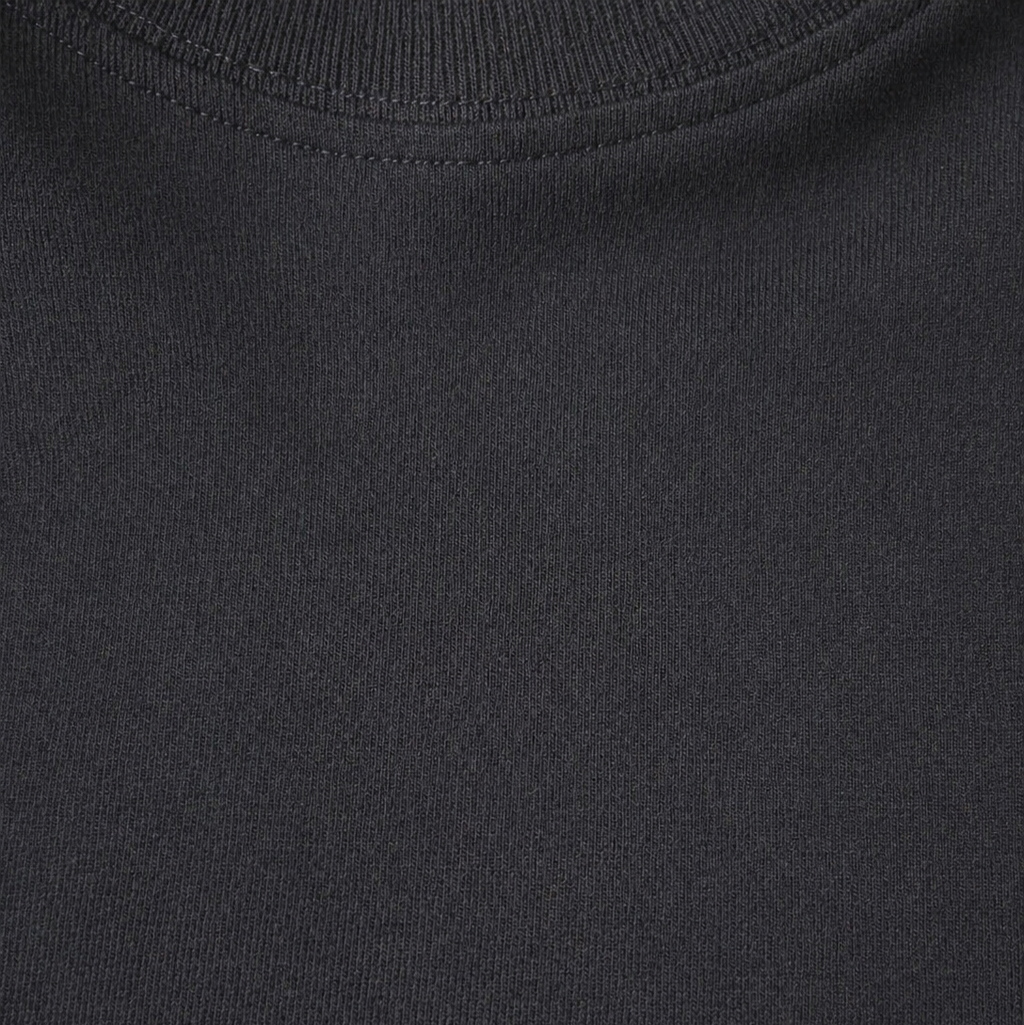 Close-up of a plain black t shirt with a visible brand logo.